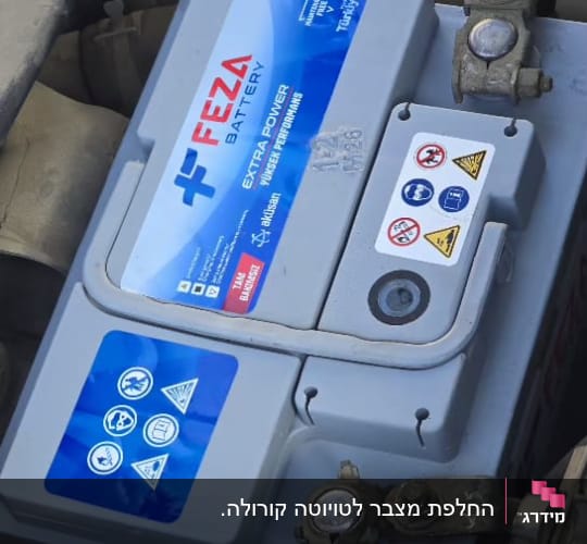 מצבר רכב עם תוויות אזהרה וחיבורים חשמליים
